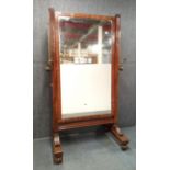 A William IV mahogany veneered gentleman's dressing mirror with attached andjustable height brass