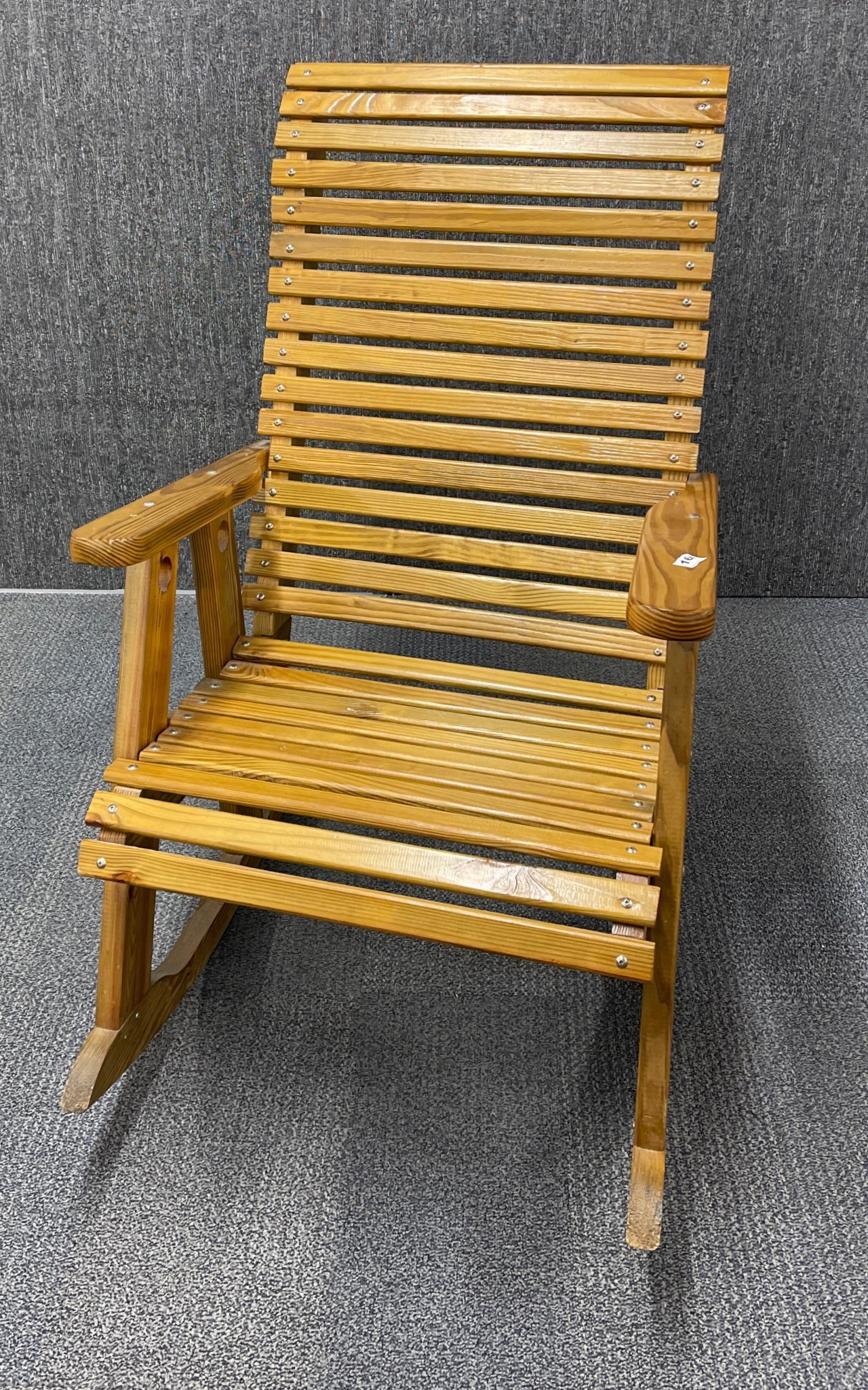 An unusual slatted pine rocking chair, W. 67cm. H. 110cm.