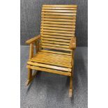 An unusual slatted pine rocking chair, W. 67cm. H. 110cm.