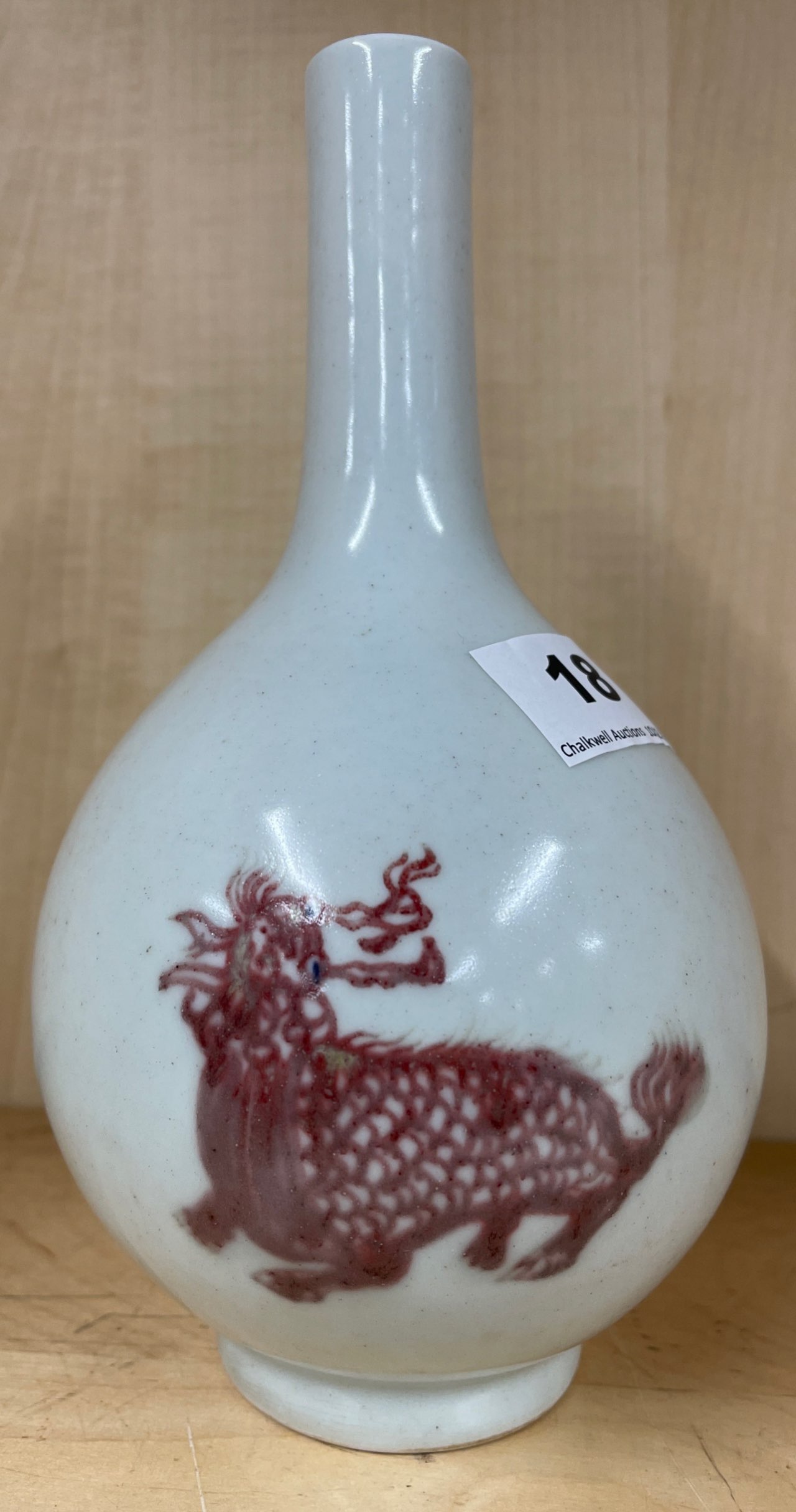 A Chinese pale celadon glazed porcelain vase with underglaze blue and red decoration of Qilin, H.