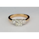 A rose metal (tested 18ct gold) trilogy ring set with three princess cut diamonds, approx. 1.37ct