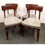 A set of four early 19th Century carved mahogany dining chairs.