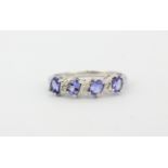 A 9ct white gold tanzanite and diamond set ring, (M).