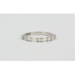 An 18ct white gold half eternity ring set with baguette and brilliant cut diamonds, approx. 0.95ct