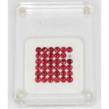 A box of unmounted round cut red spinels, approx. 2.65ct overall.