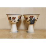 A pair of Chinese hand painted porcelain stem cups, H. 8cm. One is A/F.