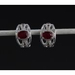 A pair of 925 silver earrings set with oval cut rubies and white stones, L. 1.6cm.