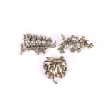 Hallmarked silver actors two faced brooch, w. 4cm, together with two further brooches.