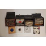 A collection of cased mixed 45 RPM records.