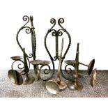 A group of wall mounted wrought iron candle sconces, largest 44cm.
