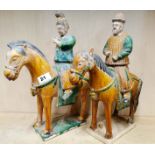 A pair of Chinese Tang Dynasty style glazed pottery horses and riders with detachable heads, H.