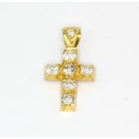 An 18ct yellow gold (stamped 18k) diamond set cross pendant, L. 2cm.