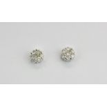 A pair of 18ct white gold diamond set cluster earrings, Dia. 0.5cm.