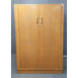 A 1970's G-plan elm double wardrobe, W. 122cm. H. 176cm.