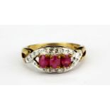 A 9ct yellow gold ring set with oval cut rubies and diamonds, (L).