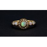A rose metal (tested minimum 9ct gold) ring set with cabochon cut opals and rose cut diamonds, (N).