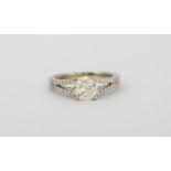 An 18ct white gold solitaire ring set with an approx. 1ct brilliant cut diamonds and diamond set