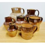 A group of Royal Doulton stoneware and other harvest jugs and tankards, largest 24cm.
