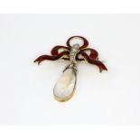 A yellow metal bow shaped enamelled pendant, set with rose cut diamonds and a cabochon cut
