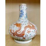 A 19th / 20th C Chinese hand enamelled porcelain vase decorated with a dragon and phoenix flying
