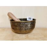 A 19th / early 20th C Tibetan bronze singing bowl with later wooden hammer, Dia. 12.5cm, H. 6cm.