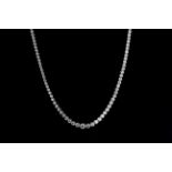 A 9ct white gold necklace set with rub over mounted graduated brilliant cut diamonds, approx. 8ct