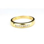 A 14ct yellow gold princess cut diamond set half eternity ring, (S.5).