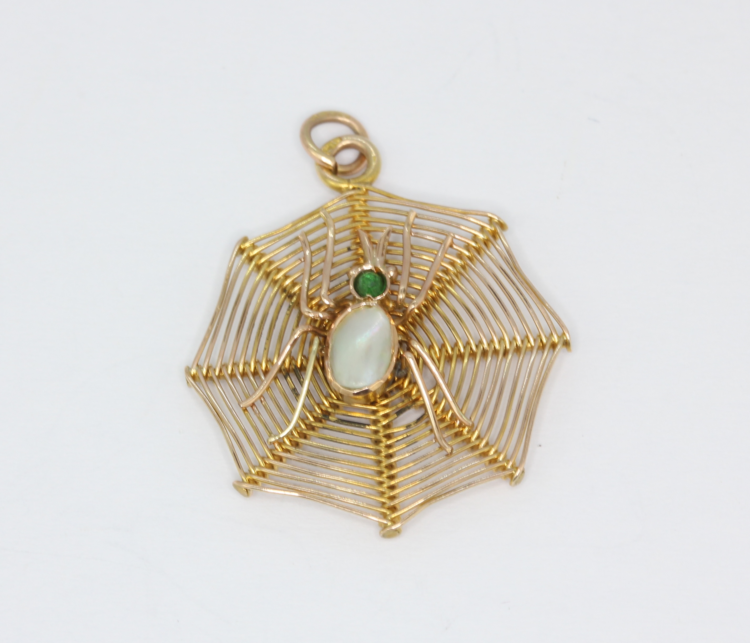 A 9ct yellow gold (stamped 9ct) spider web shaped pendant, set with mother of pearl and emeralds, L. - Image 2 of 3