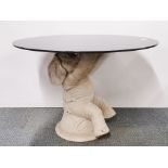 An interesting resin elephant table and circular black glass top, H. 57cm x Dia. 79cm. (Some