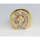 A gentleman's yellow metal (tested high carat gold) diamond set horseshoe shaped ring, (N.5).
