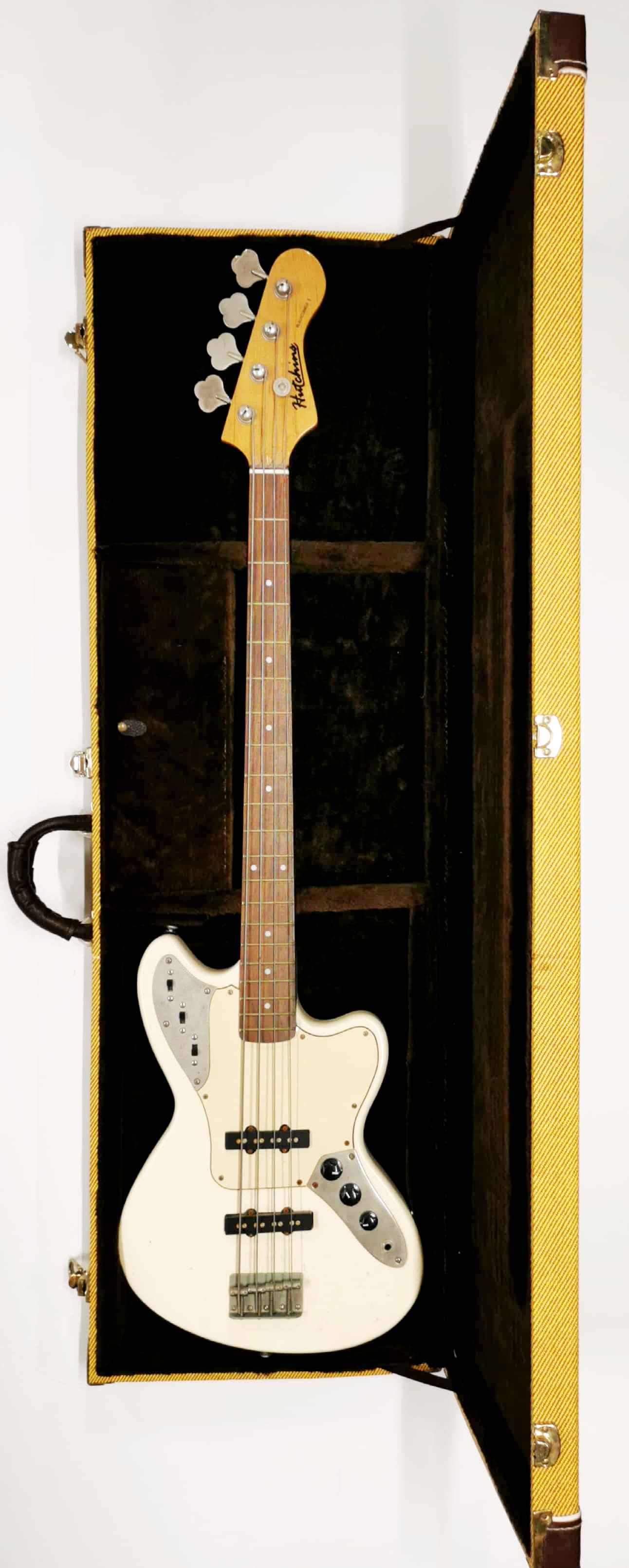 A cased Hutchins base guitar.