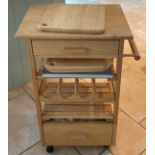 A moveable pine kitchen island with chopping boards, W. 51cm. H.83.5cm.
