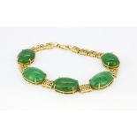 An 18ct yellow gold (stamped 750) jade set bracelet, with a GCS certificate, L. 16cm.