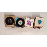 A collection of mixed 45 RPM records.