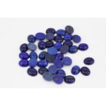 A quantity of unmounted cabochon cut lapis lazuli, approx. 101ct overall.