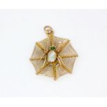 A 9ct yellow gold (stamped 9ct) spider web shaped pendant, set with mother of pearl and emeralds, L.