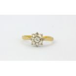 An 18ct yellow gold (stamped 18ct) diamond set cluster ring, (N).
