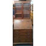 A 1920's Georgian style walnut veneered bureau bookcase, W. 87cm. H. 201cm.