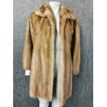 A ladies vintage blonde mink jacket.