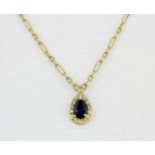 A boxed 18ct yellow gold necklace set with a pear cut sapphire and diamonds, L. 1.5cm.