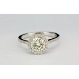 An 18ct white gold (stamped 750) halo ring set with a brilliant cut diamond surrounded by