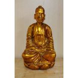 An early 20th C Burmese gilt carved wood figure of a seated Buddha, H. 20cm.