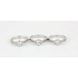 Three silver stone set solitaire rings.
