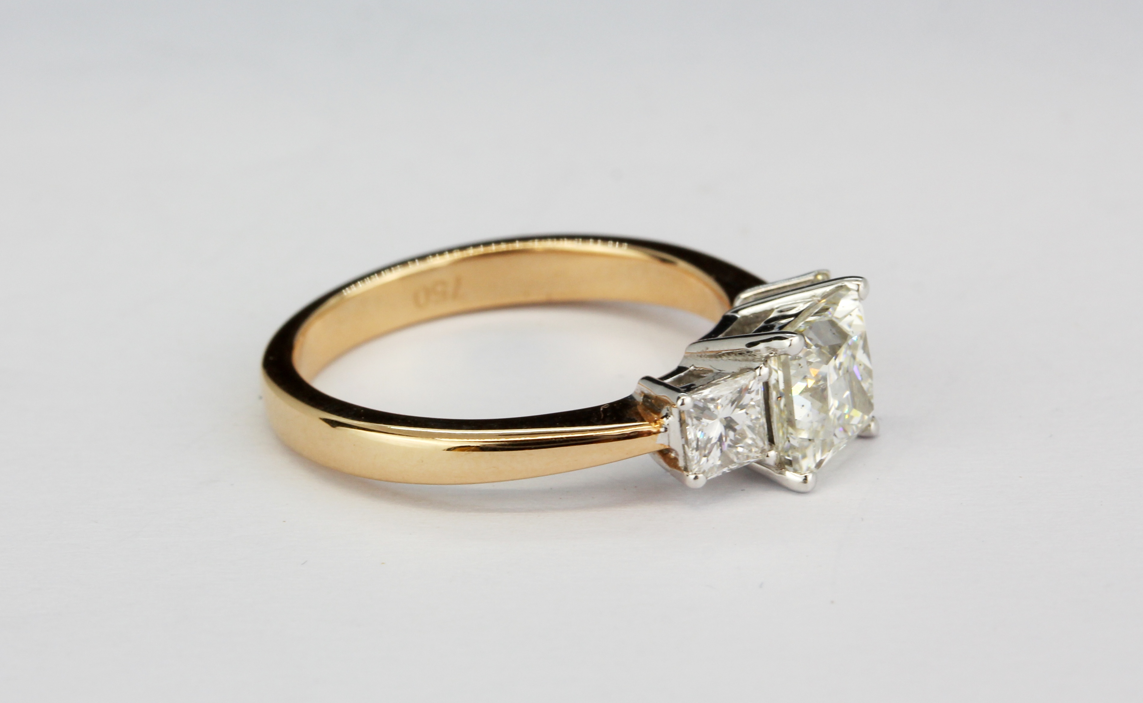 A rose metal (tested 18ct gold) trilogy ring set with three princess cut diamonds, approx. 1.37ct - Image 2 of 2