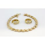 A 14ct yellow gold (stamped 14k) bracelet set with baguette cut diamonds and matching pair of hoop