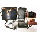 An early Bell and Howell model 605, 8mm cine camera and three further cameras.