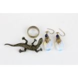 A silver and marcasite lizard brooch and a silver ring together with a pair of silver drop