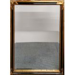 A large gilt framed bevelled mirror, 104cm x 132cm.