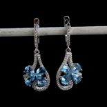 A pair of 925 silver flower shaped drop earrings set with pear cut blue topaz and white stones, L.