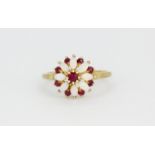 A 9ct yellow gold opal and ruby set cluster ring, (N.5).